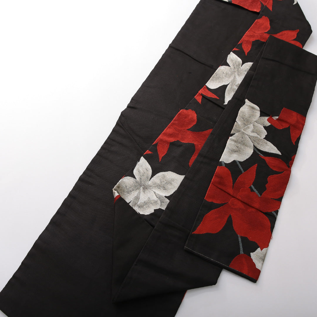 九寸名古屋帯 帯丈359cm カジュアル 名古屋仕立て 六通 Cランク 正絹 綴れ織 百合 黒系 1224-03822