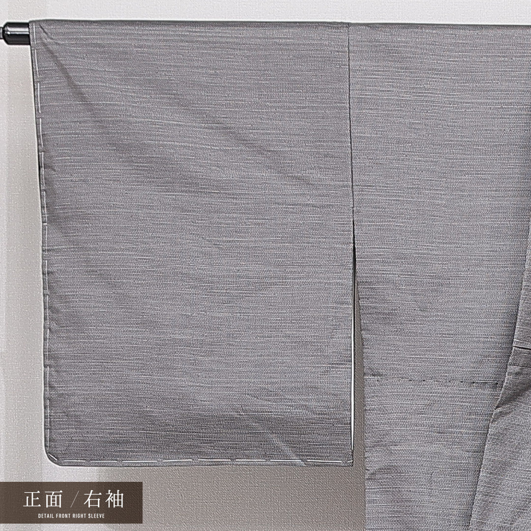 未使用品 大島紬 袷 身丈170cm 裄丈68cm 正絹 Nランク インフォーマル 広衿 2XLサイズ 経緯絣 染め紬 ガード加工 しつけ糸 雪輪 グレー系 PO 1223-15043